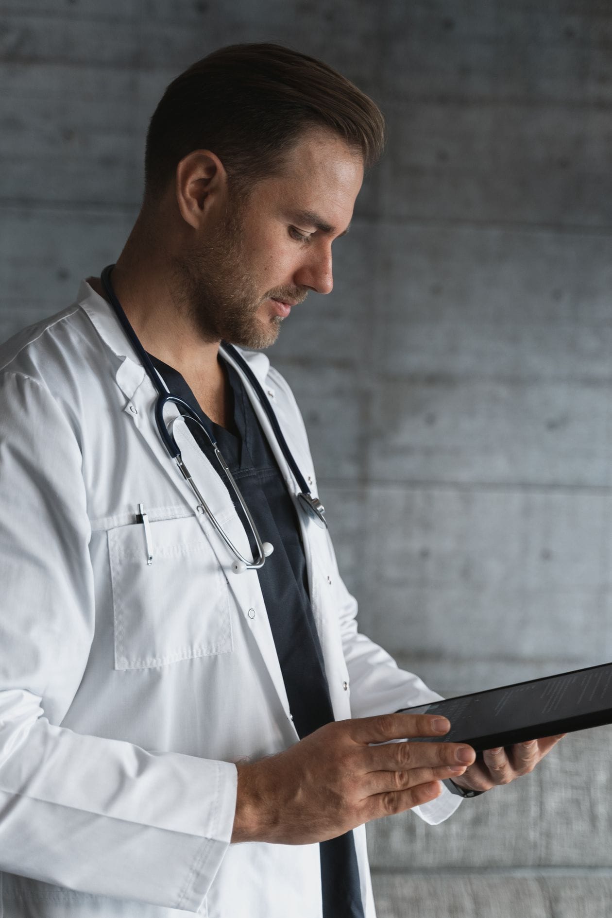 Physician reviewing a tablet (illustrative photo)